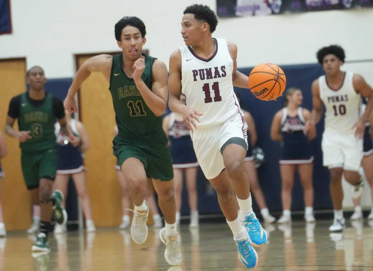 Arizona high school basketball: Perry Pumas guard No No Brown (11) brings the ball upcourt against the Basha Bears at Perry High School.